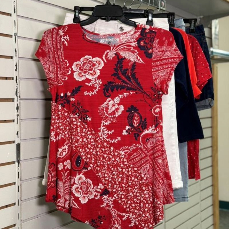 Red shirt with a pattern hanging on a hanger